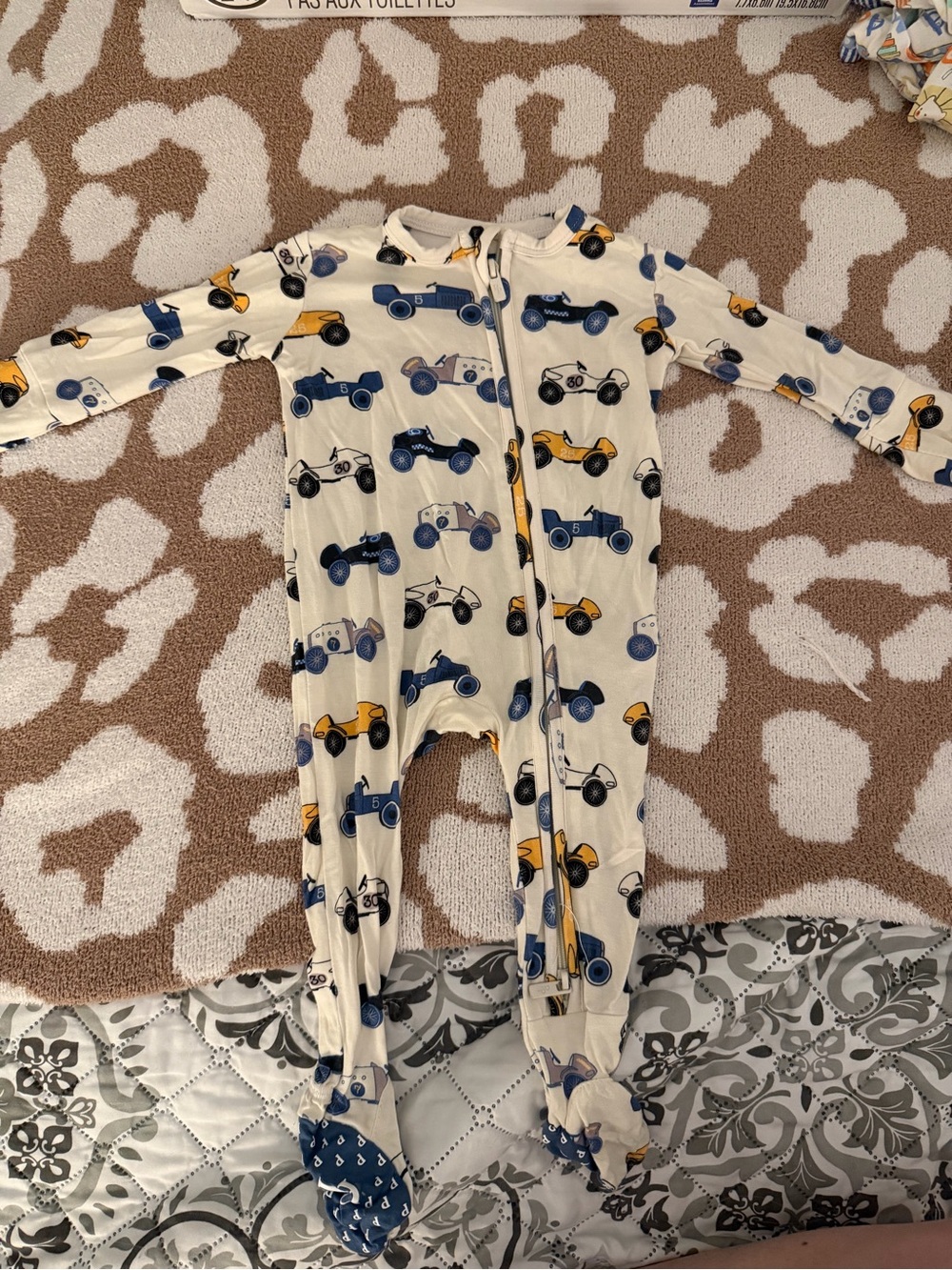 Posh Peanut Cream Footed One-Piece with Blue & Yellow Racecars